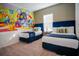 Charming bedroom features twin beds, colorful Disney mural, and natural light at 2166 Derwent Dr, Davenport, FL 33896