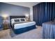 Cozy bedroom featuring a large bed with tufted headboard, soft carpet, and gray accent wall for a serene retreat at 2166 Derwent Dr, Davenport, FL 33896