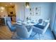 Bright dining area features a modern table with six chairs, accented by stylish lighting and décor at 2166 Derwent Dr, Davenport, FL 33896
