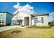 Single-story home with an attached garage is accented by a manicured lawn and blue skies with white clouds at 2166 Derwent Dr, Davenport, FL 33896