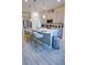 Modern kitchen boasts an island with barstool seating and pendant lights, perfect for casual dining at 2166 Derwent Dr, Davenport, FL 33896