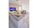 Relax in this large living room with a gray sectional and light floors, perfect for movie nights and gatherings at 2166 Derwent Dr, Davenport, FL 33896