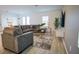 Spacious living room with large couch, neutral tones, bright lighting, and modern decor for ultimate comfort at 2166 Derwent Dr, Davenport, FL 33896