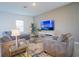Cozy living room offers comfortable seating, stylish decor, and a bright atmosphere for relaxation and entertainment at 2166 Derwent Dr, Davenport, FL 33896