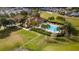 Community pool with palm trees, deck chairs, and a view of neighborhood homes at 2166 Derwent Dr, Davenport, FL 33896