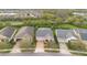 Aerial view of a well-manicured single-Gathering home with a brick driveway in a quiet neighborhood at 2460 Promenade Dr, St Cloud, FL 34772