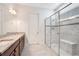 Bathroom featuring a large glass enclosed shower, double vanity and tiled floor at 2460 Promenade Dr, St Cloud, FL 34772
