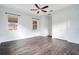 This bedroom features sleek hard floors, cool color palette and a ceiling fan at 2460 Promenade Dr, St Cloud, FL 34772