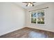 Bedroom featuring sleek hardwood floors and a large window at 2460 Promenade Dr, St Cloud, FL 34772
