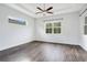 Bright and airy bedroom featuring neutral walls, hardwood floors, and ample natural light at 2460 Promenade Dr, St Cloud, FL 34772