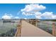 Community dock and boat lift on the water offers a serene setting for boating and waterfront enjoyment at 2460 Promenade Dr, St Cloud, FL 34772
