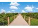 Scenic walkway leads to a gazebo overlooking the water, perfect for enjoying nature and relaxing outdoors at 2460 Promenade Dr, St Cloud, FL 34772