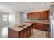 Modern kitchen featuring dark cabinetry, granite countertops, and a center island at 2460 Promenade Dr, St Cloud, FL 34772