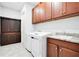 Laundry room with new washer/dryer, granite countertop and dark cabinets at 2460 Promenade Dr, St Cloud, FL 34772