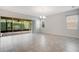 Open concept living area featuring tile flooring, large windows, and access to the screened patio at 2460 Promenade Dr, St Cloud, FL 34772