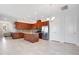 Bright open space with hardwood cabinets, stainless appliances, and access to living room and dining area at 2460 Promenade Dr, St Cloud, FL 34772