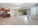 Inviting living area combining the kitchen and living room with tiled floors and access to the patio at 2460 Promenade Dr, St Cloud, FL 34772