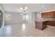 Bright open living space with hardwood cabinets, stainless appliances, and access to screened patio at 2460 Promenade Dr, St Cloud, FL 34772