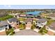 Aerial view of neighborhood homes surrounding a community lake and fountain, showcasing a tranquil residential setting at 2468 Varenna Loop, Kissimmee, FL 34741