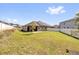 Expansive backyard featuring a well-maintained lawn and a privacy fence, ideal for outdoor activities and relaxation at 2468 Varenna Loop, Kissimmee, FL 34741