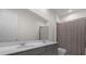 Bathroom with a double sink vanity and a large mirror, next to a shower/tub with a striped curtain at 2468 Varenna Loop, Kissimmee, FL 34741