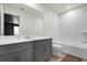 Bright bathroom featuring a tub with white subway tile and a gray vanity with a white countertop at 2468 Varenna Loop, Kissimmee, FL 34741