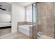 Luxurious bathroom with a separate tub and glass shower, complemented by neutral tiling for a spa-like feel at 2468 Varenna Loop, Kissimmee, FL 34741