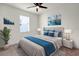 A stylish bedroom features a large bed with blue accents, complemented by elegant nightstands and modern decor at 2468 Varenna Loop, Kissimmee, FL 34741