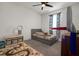 Bright bedroom features a ceiling fan, comfortable bed, and colorful decor, perfect for a space at 2468 Varenna Loop, Kissimmee, FL 34741