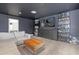 Stylish bonus room with a large TV, comfortable seating, and unique decor for entertainment at 2468 Varenna Loop, Kissimmee, FL 34741