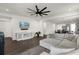 Spacious living room with a modern ceiling fan, contemporary decor, and an open view into the dining and kitchen areas at 2468 Varenna Loop, Kissimmee, FL 34741