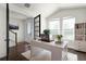 Bright home office with vaulted ceilings, large windows, and a modern desk, creating an ideal workspace at 2468 Varenna Loop, Kissimmee, FL 34741
