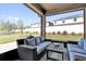 Cozy screened patio featuring a comfortable seating arrangement, perfect for relaxing outdoors at 2468 Varenna Loop, Kissimmee, FL 34741