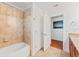 Bathroom with tiled shower and flooring and dark wood cabinets with granite countertops at 2814 Plymouth Pl, Kissimmee, FL 34741