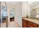 Bathroom featuring a granite vanity top, step-in glass shower, and doorway to the main bedroom at 2814 Plymouth Pl, Kissimmee, FL 34741
