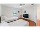 Bedroom featuring hardwood floors, two twin beds, ceiling fan, and bright natural light at 2814 Plymouth Pl, Kissimmee, FL 34741