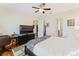 Large bedroom with a zebra print throw, television, ceiling fan, and doorway to the kitchen at 2814 Plymouth Pl, Kissimmee, FL 34741