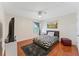 Cozy bedroom with modern decor, wood floors, zebra print bedspread, and a ceiling fan at 2814 Plymouth Pl, Kissimmee, FL 34741