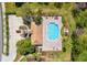 Overhead view of the community pool area, featuring ample seating, lush landscaping, and a convenient parking lot at 2814 Plymouth Pl, Kissimmee, FL 34741