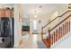 Foyer with staircase, tile flooring, chandelier, and a view into the living area and kitchen at 2814 Plymouth Pl, Kissimmee, FL 34741