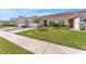 Charming home with a well-manicured lawn and a paved driveway leading to a two-car garage at 2814 Plymouth Pl, Kissimmee, FL 34741