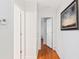 Hallway featuring hardwood floors, white walls, and white doors throughout the home at 2814 Plymouth Pl, Kissimmee, FL 34741