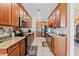 Traditional kitchen featuring granite countertops, stainless steel appliances, and tile flooring at 2814 Plymouth Pl, Kissimmee, FL 34741