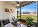 Relaxing screened lanai with comfortable seating, a ceiling fan, and a view of the lush backyard at 2814 Plymouth Pl, Kissimmee, FL 34741