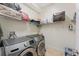 Laundry room with a newer washer and dryer and overhead wire shelving for storage at 2814 Plymouth Pl, Kissimmee, FL 34741