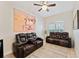 Living room with tiled floors, leather sofas, overhead ceiling fan, and lots of natural light at 2814 Plymouth Pl, Kissimmee, FL 34741