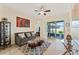 Cozy living room featuring tile floors, a ceiling fan, comfortable seating and sliding glass doors to the outdoor patio at 2814 Plymouth Pl, Kissimmee, FL 34741