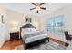 Serene bedroom featuring a comfortable queen bed, stylish decor, and a bright window with natural light at 2814 Plymouth Pl, Kissimmee, FL 34741