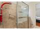 Walk-in shower with tiled walls, a bench, and a clear glass door in neutral tones at 2814 Plymouth Pl, Kissimmee, FL 34741