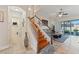 Elegant staircase with wooden treads and white railings, leading to the upper level, open to the living area at 2814 Plymouth Pl, Kissimmee, FL 34741